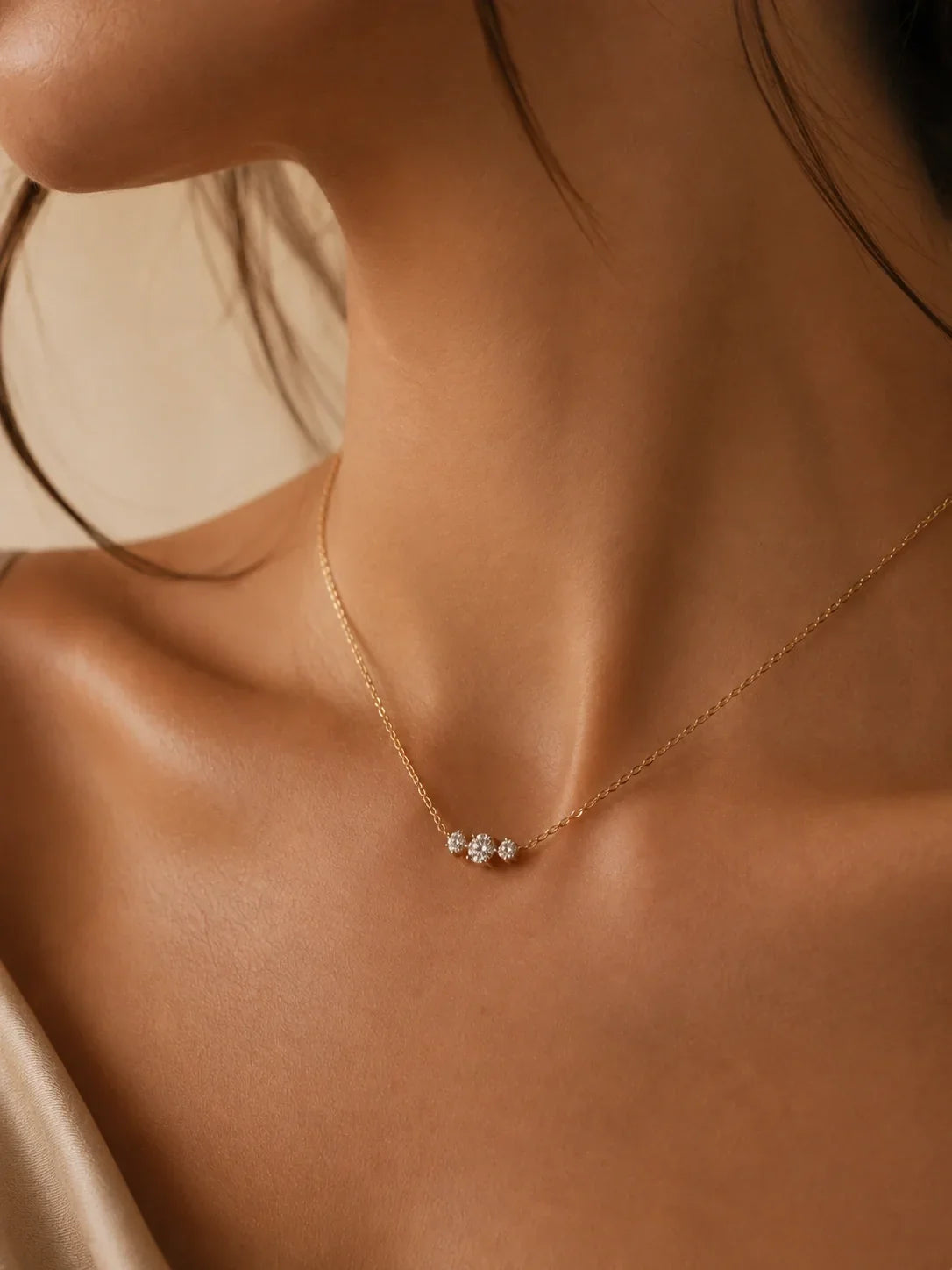 The Trio Diamond Necklace in solid 18K gold worn at the neckline, a first Christmas together gift for her