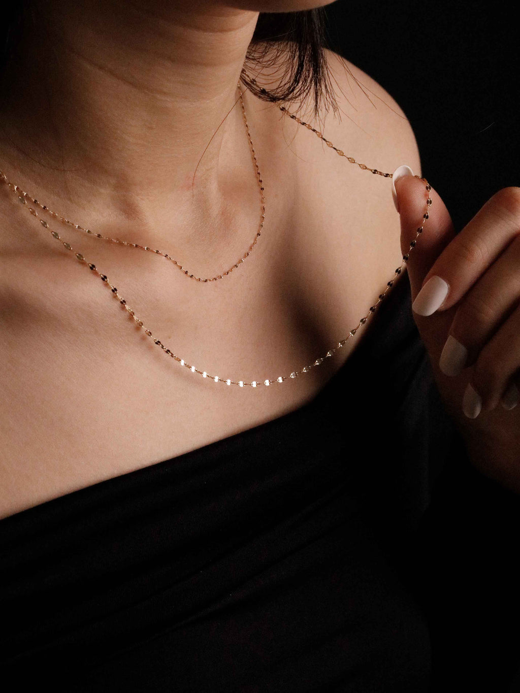 gold necklace on neck 