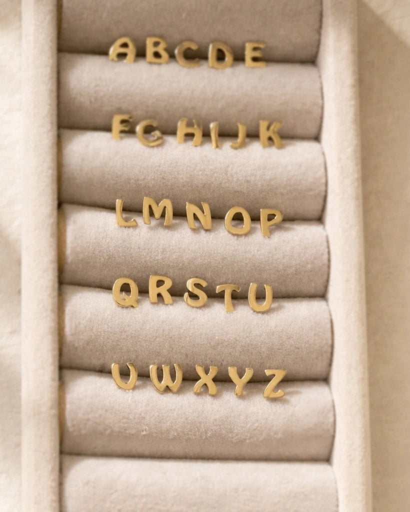 Gold letters on beige fabric with a neutral background