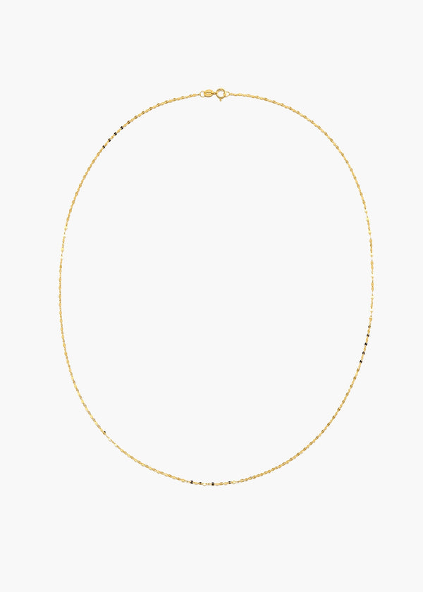 A delicate gold chain necklace with small, evenly spaced black beads, displayed in an oval shape against a solid white background.