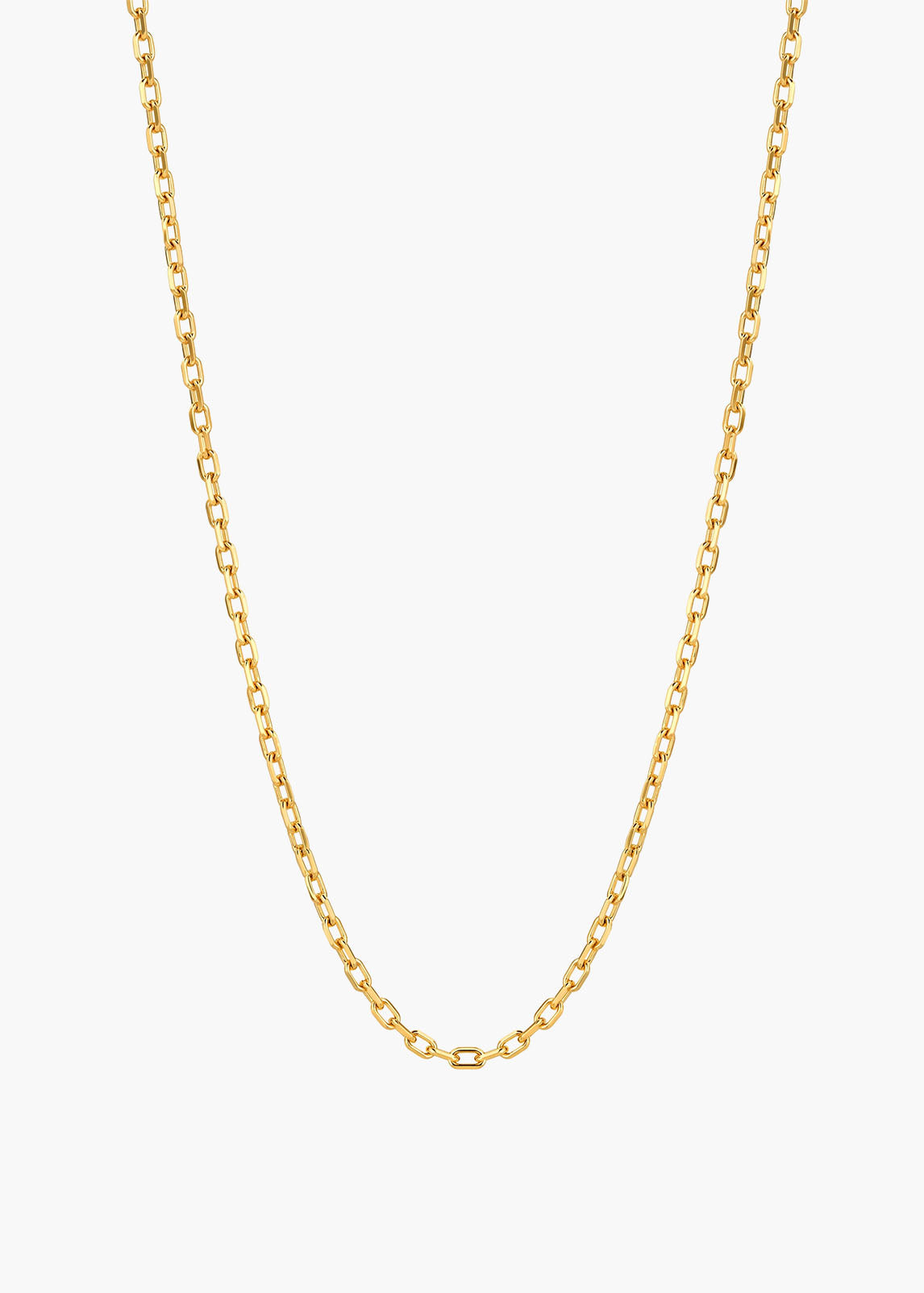 A delicate gold chain necklace with a classic curb link design, displayed against a clean, light off-white background.