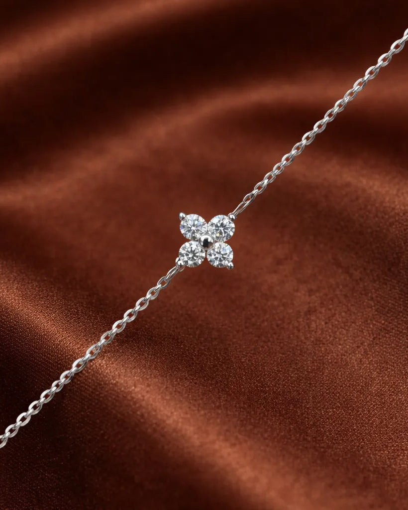 Silver bracelet with a star-shaped clasp on a brown fabric background