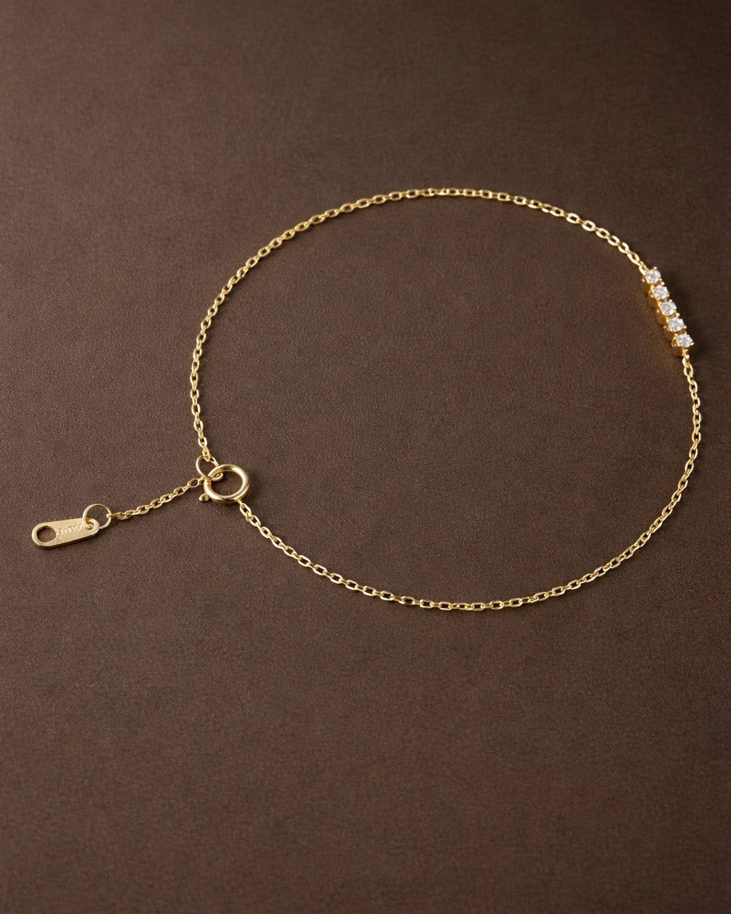 Gold anklet on a brown background