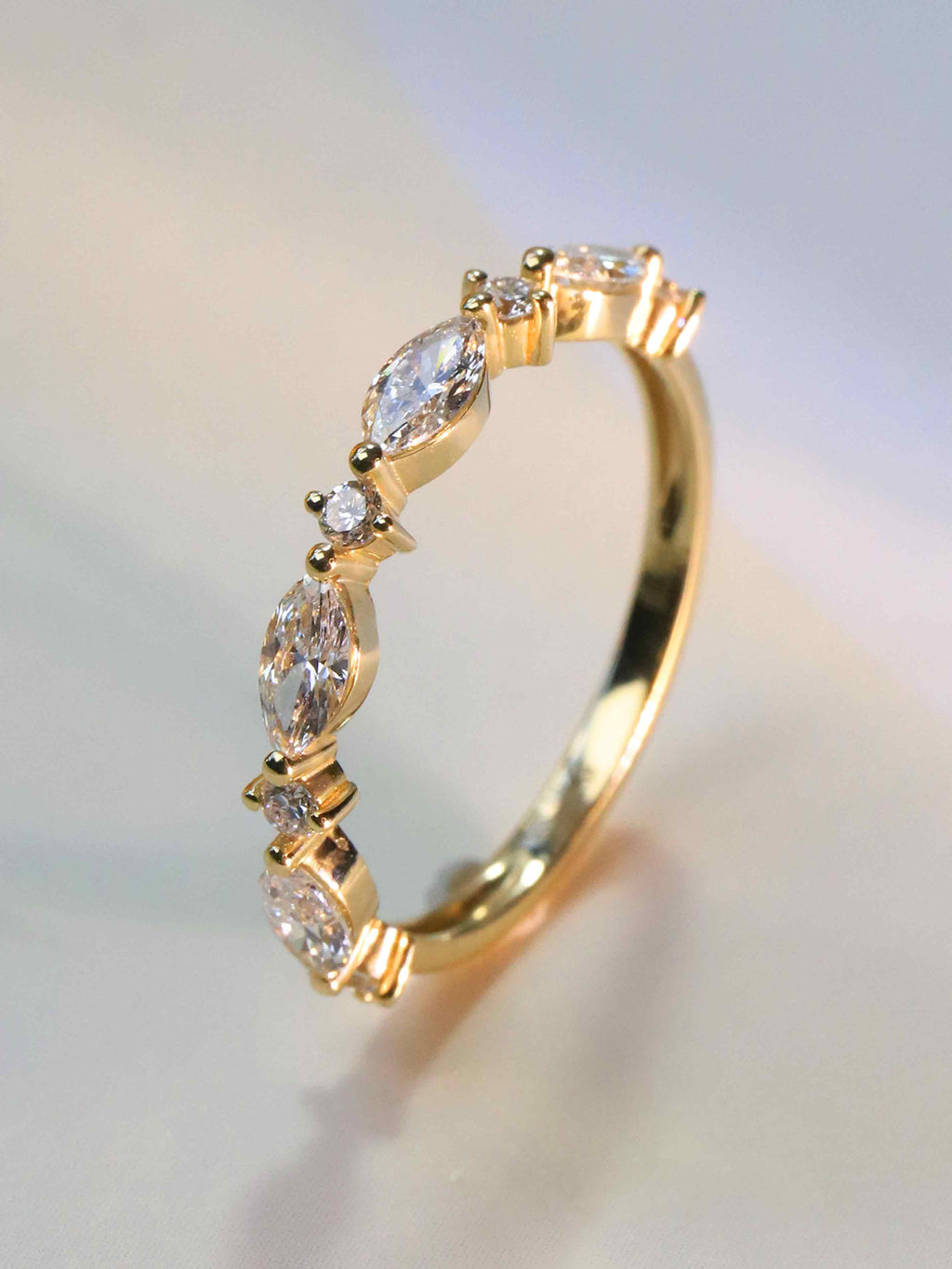 Close-up of 4 marquise and 5 round lab diamonds (2.3ct) in prong setting