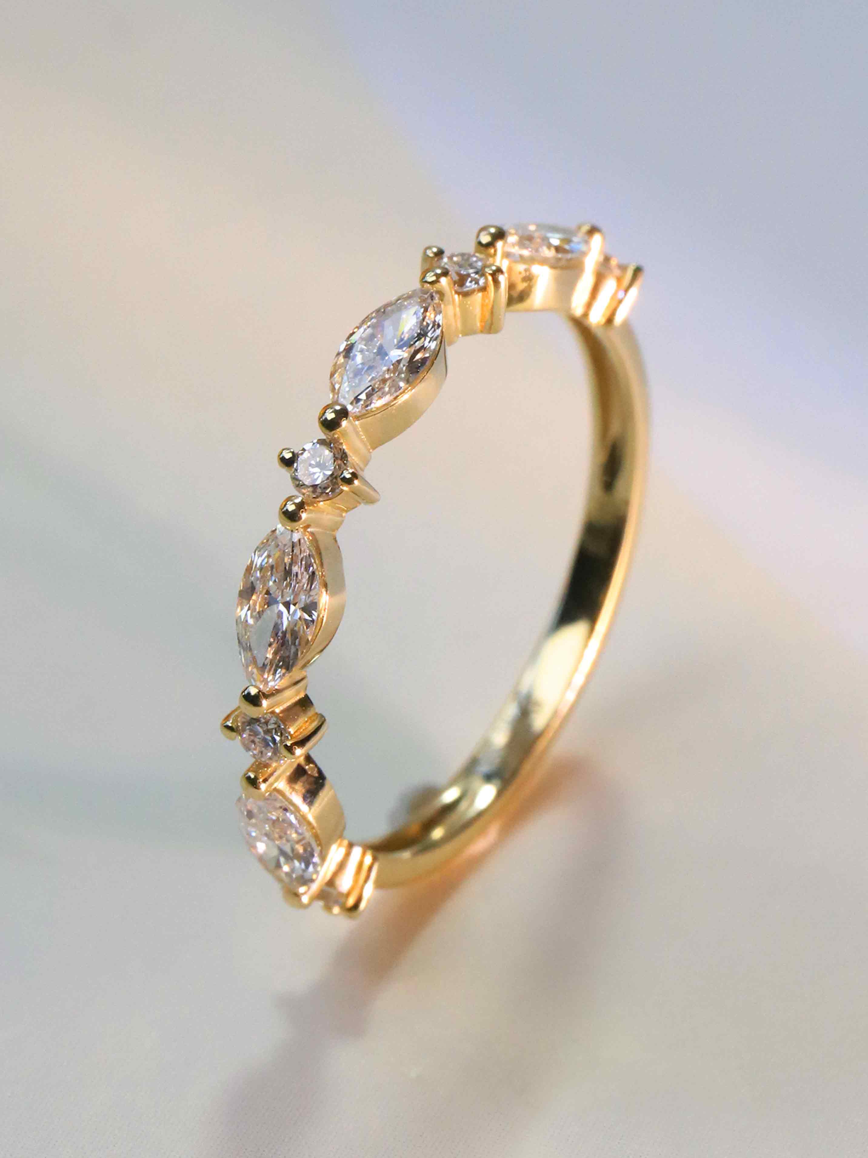 Close-up of 4 marquise and 5 round lab diamonds (2.3ct) in prong setting
