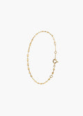 A delicate gold chain bracelet with alternating small diamond-shaped links and open circle links, featuring a spring-ring clasp, displayed on a clean white background.