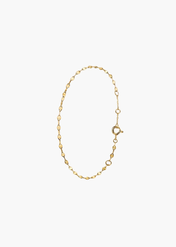 A delicate gold chain bracelet with alternating small diamond-shaped links and open circle links, featuring a spring-ring clasp, displayed on a clean white background.