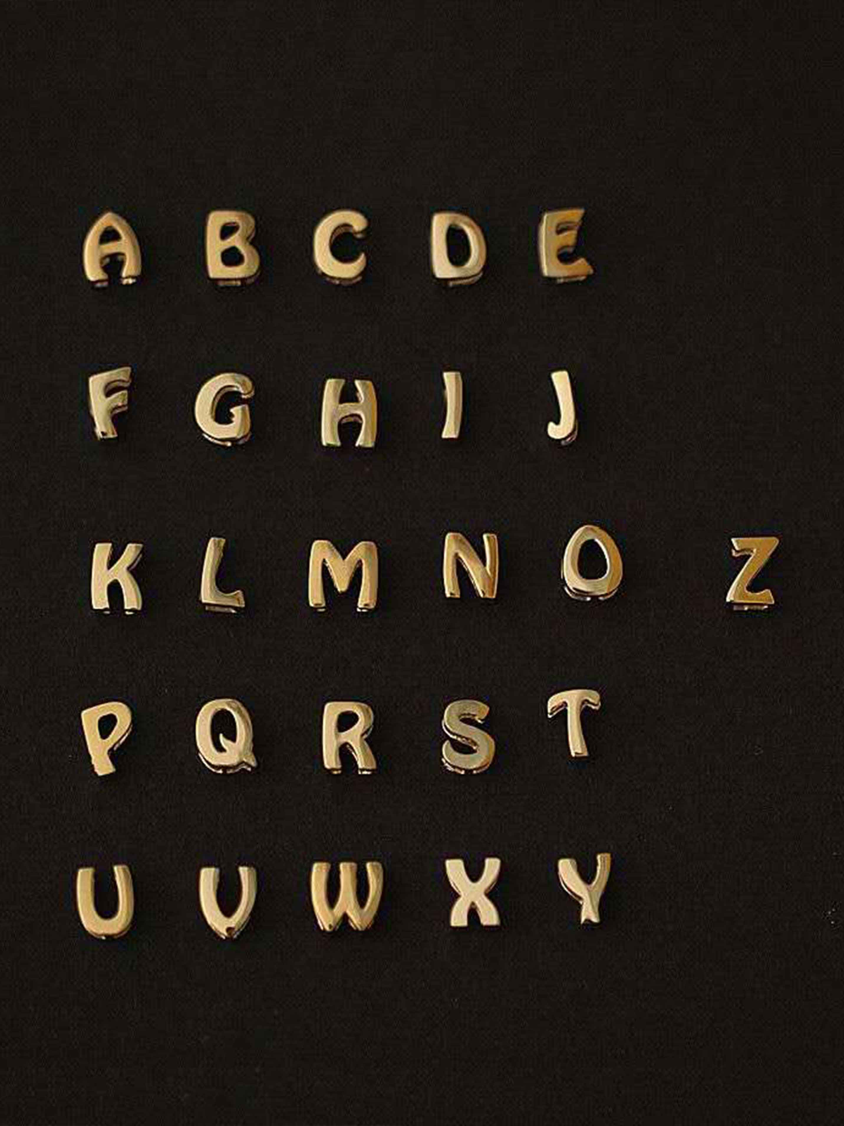 Gold alphabet letters on a black background